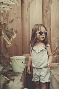 Girl wearing sunglasses standing outdoors