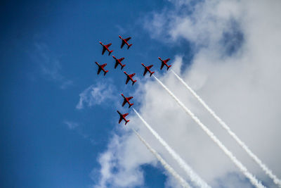 Low angle view of airplane flying against sky