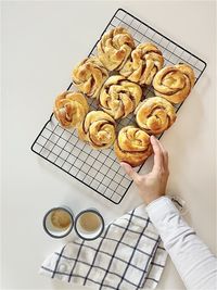 High angle view of hand holding cookies on table