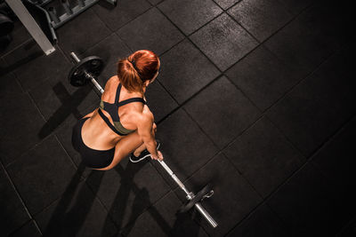 High angle view of woman sitting on floor