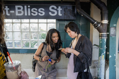 Friends at a train station in queens, new york