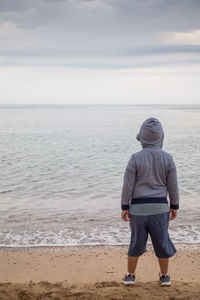 Rear view of man standing on beach