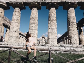 Low angle view of woman with arms outstretched