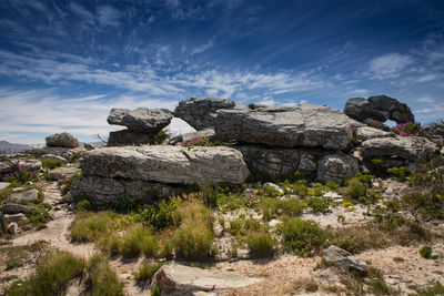 Built structure on rock formation against sky