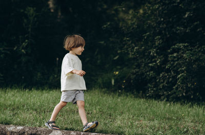 Full length of boy standing on field