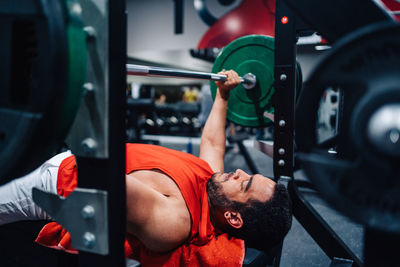 Rear view of man exercising in gym