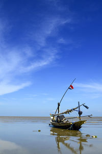 Sailboat in sea against sky