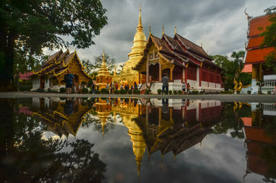 Reflection of building on lake against sky