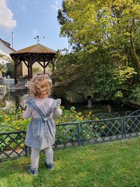 Rear view of girl standing on land in park