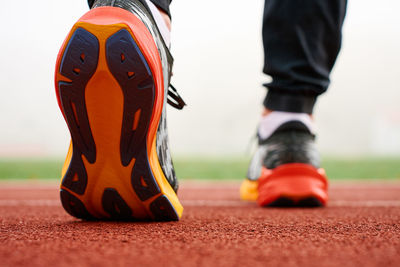 Low section of man standing on footpath
