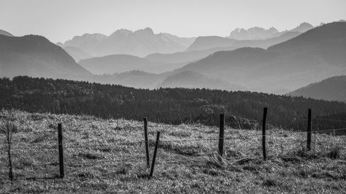 Scenic view of field and mountains against sky