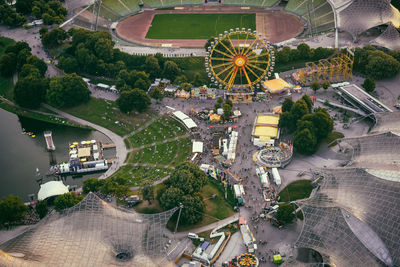 High angle view of ferris wheel by buildings in city