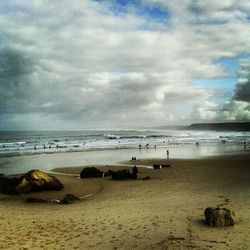 Scenic view of sea against cloudy sky