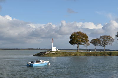 Scenic view of lighthouse by sea against sky