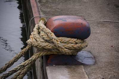 High angle view of rope tied on pier