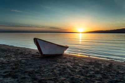 Scenic view of beach against sky during sunset