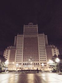 Illuminated buildings against sky at night