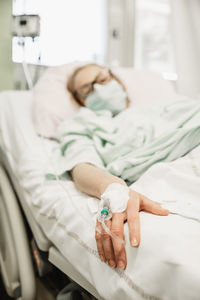 High angle view of woman lying on bed at home