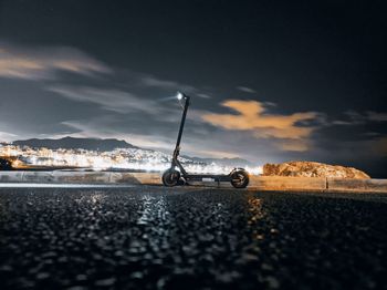 Cars on road by sea against sky