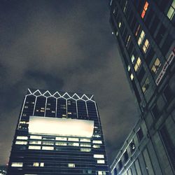 Low angle view of buildings against sky at night