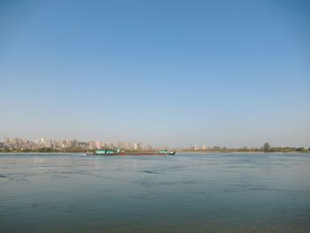 Scenic view of sea against clear blue sky