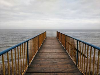 Pier over sea against sky