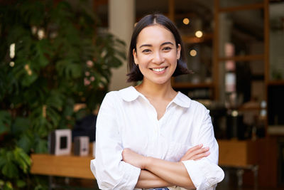 Portrait of young woman standing outdoors