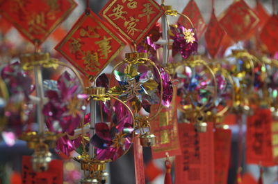 Close-up of decorations hanging in market for sale