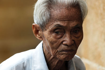 Close-up portrait of man against blurred background