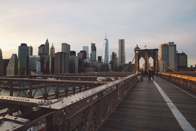 People walking on bridge in city