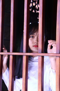 Portrait of girl looking through window