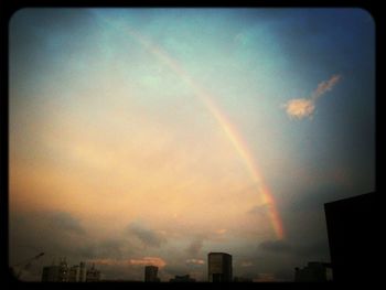 Scenic view of rainbow over city