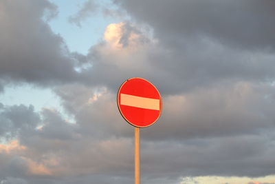 Low angle view of road sign against sky