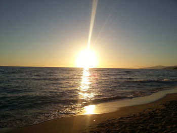 Scenic view of sea against clear sky at sunset