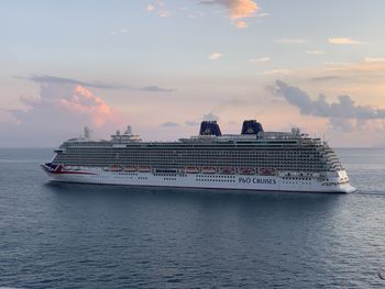 Nautical vessel on sea against sky during sunset