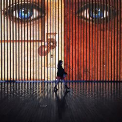 Young woman standing on tiled floor