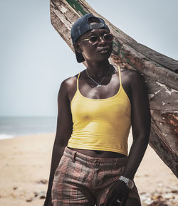 African woman standing on a beach at a boat in the cape coast located in ghana west africa.