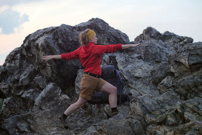 Rear view of person on rock at mountain