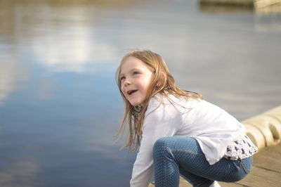 Portrait of smiling girl against lake