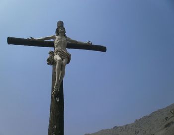 Low angle view of statue against clear blue sky