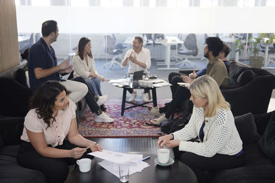 Group of business people having meeting in lobby