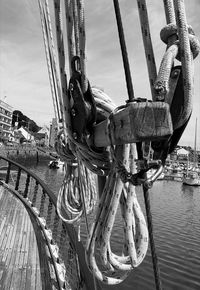 Close-up of ship moored at harbor against sky