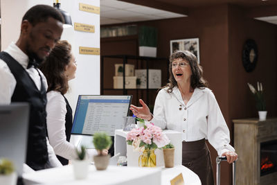 Young woman using digital tablet while sitting in office