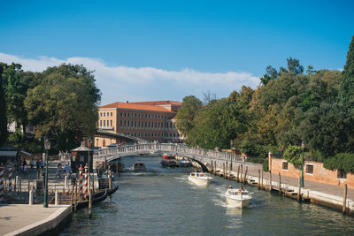 Scenic view of river by buildings against sky