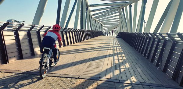 Rear view of man riding bicycle