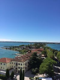 High angle view of houses against blue sky