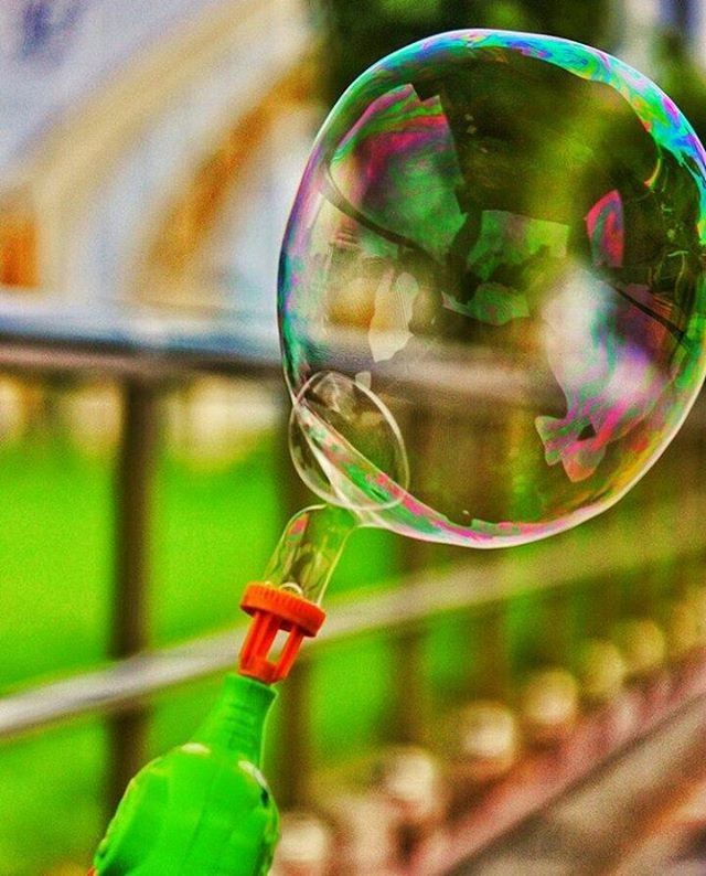 focus on foreground, close-up, multi colored, green color, transparent, glass - material, indoors, selective focus, bubble, reflection, motion, no people, day, mid-air, glass, fragility, still life, water, sphere