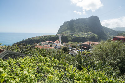 Scenic view of sea and buildings against sky