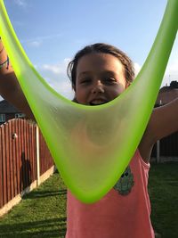 Portrait of smiling girl playing with slimy