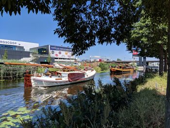 Boats moored in lake against sky